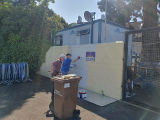 Kilmacud Crokes Men's Shed painting the walls surrounding Glenalbyn House