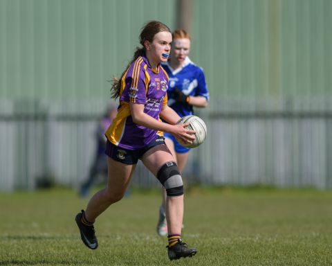 Kilmacud number 21 running with the ball
