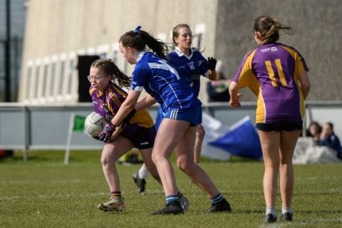 Kilmacud number 14 bursting through a tackle