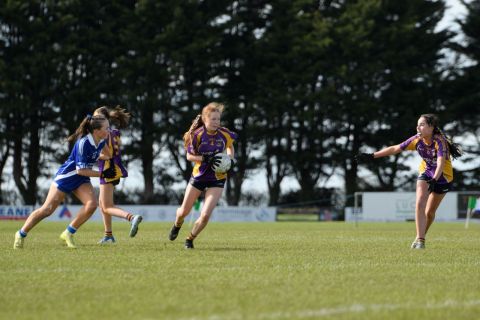 Kilmacud number four running with ball