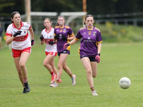 Kilmacud no 18 running after ball on ground