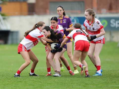 Kilmacud player under pressure from three Whitehall players