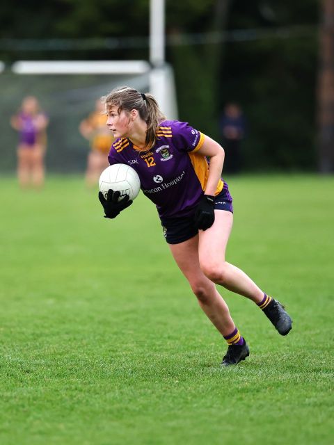 Kilmacud no 12 holds the ball and weighs up her options