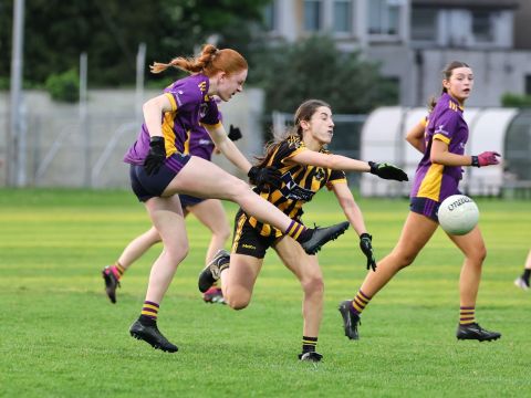 Kilmacud no 5 kicks ball away, under pressure